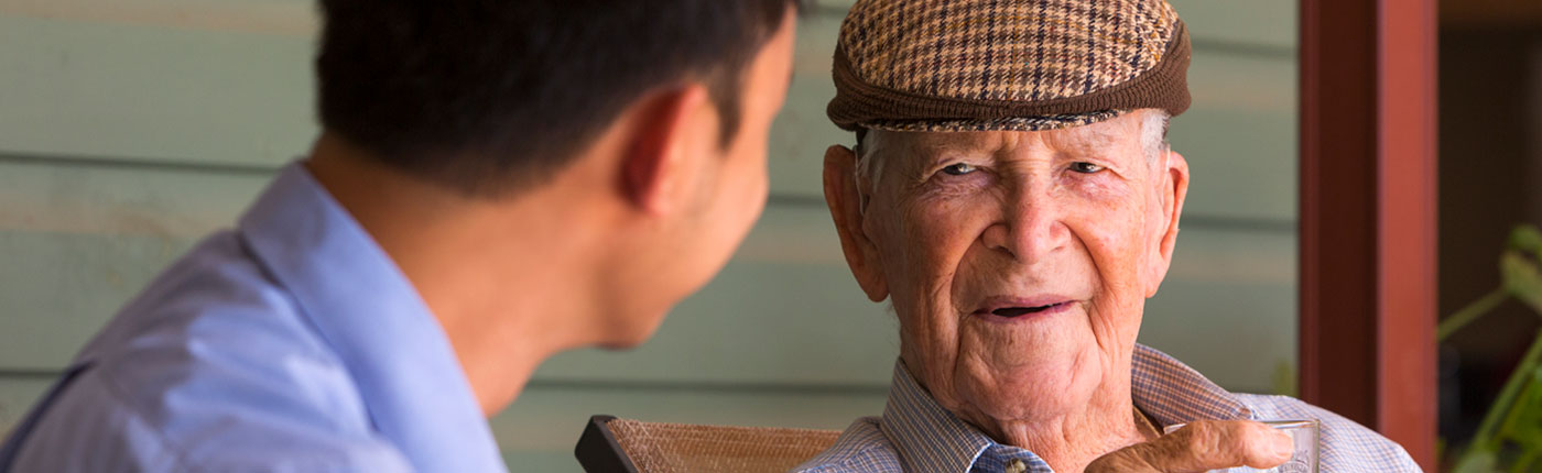 Aged Care worker is having conversation with the resident