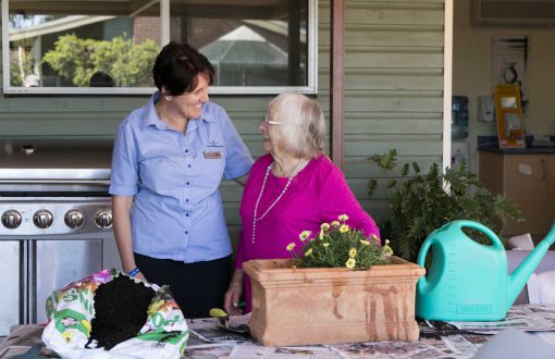 A Whiddon carer with a resident doing some gardening as part of a Whiddon creative ageing program.