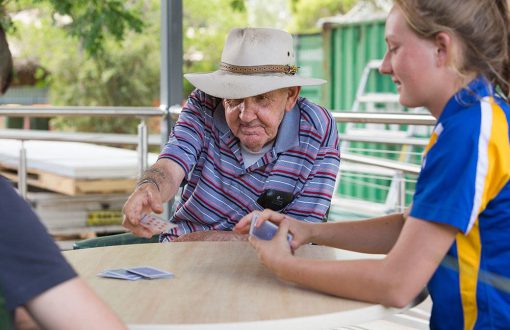 A resident playing cards with some aged care volunteers at Whiddon Narrabri Jessie Hunt.