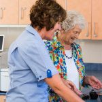 A carer and resident enjoying cooking together at Whiddon's community care home on the mid north coast.