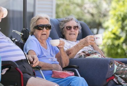 Two residents chatting together over tea at one of Whiddon's aged care homes.