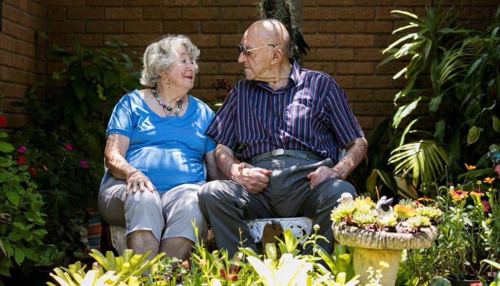 Two Whiddon residents enjoying some quality time together in a garden at an aged care home in Port Macquarie.