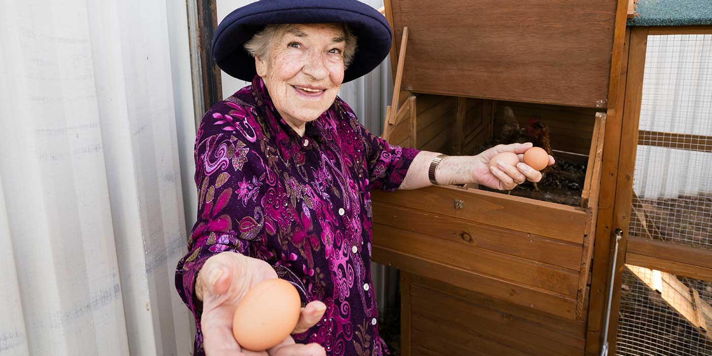 A resident holding eggs that were collected during HenPower, a creative ageing program from Whiddon.