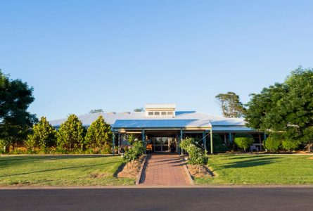 Whiddon Wee Waa's front entrance, surrounded by tall trees and a manicured lawn.