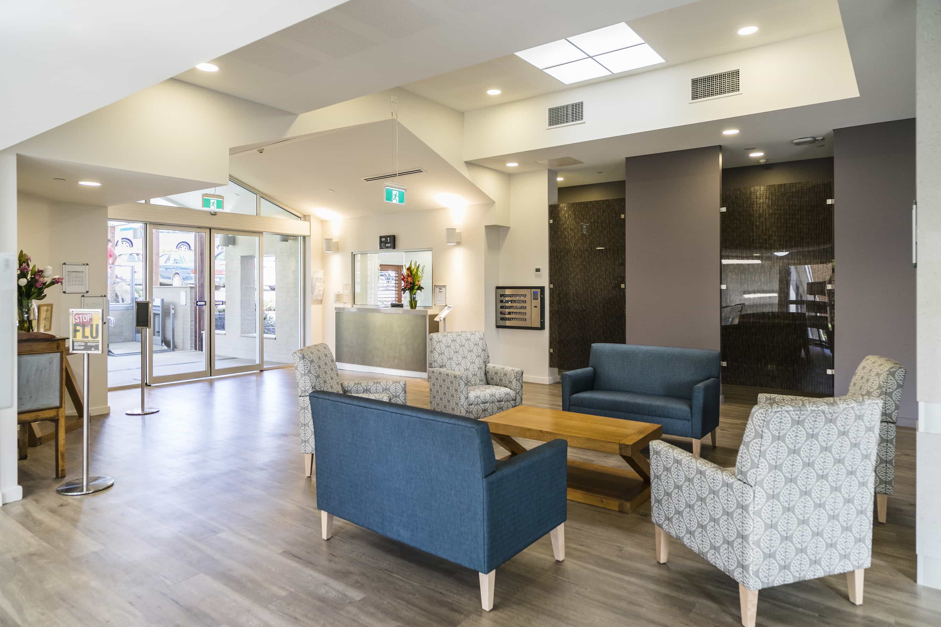 Whiddon Maclean's modern lobby, fitted with couches and a coffee table.