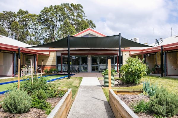 The spacious backyard of Whiddon's nursing home in Bathurst, fitted with a sheltered seating area and lively plants.