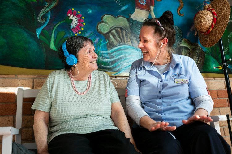 A Whiddon resident and carer enjoying some music together as part of Whiddon's music therapy program.