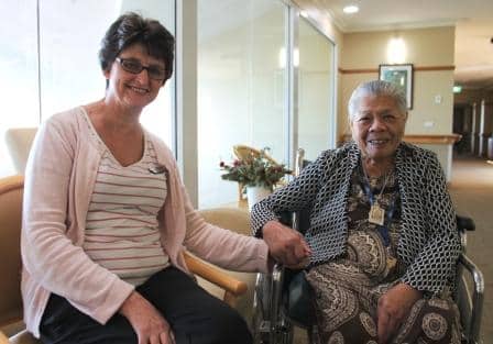 Lynda Neil, care manager at Whiddon Easton Park, smiling next to a resident.