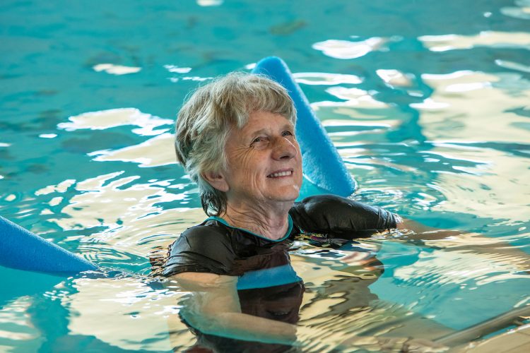 senior lady doing hydroptherapy in swimming pool at Whiddon aged care home
