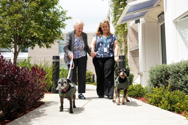 aged care resident walking dog as part of Whiddon Creature Comforts Program