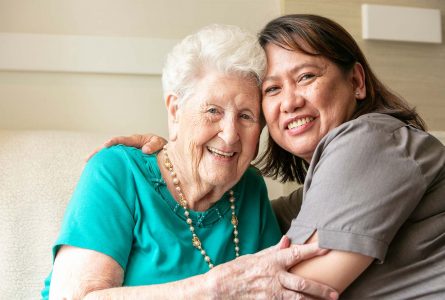 A Whiddon Moree carer and resident hugging each other, highlighting the close bond formed between carers and residents.