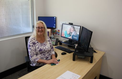 New Care Manager Deb smiling in her office at Whiddon Beaudesert Star, an aged care home in Beaudesert.