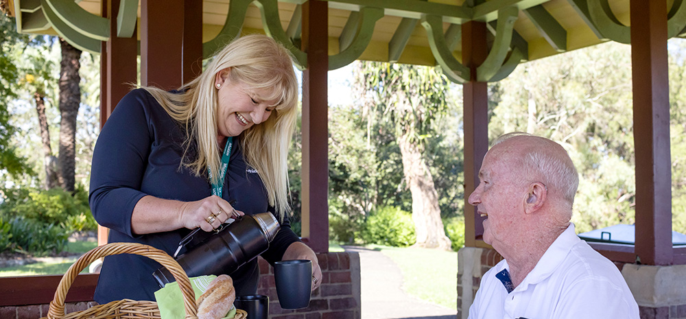 Whiddon community care worker having a picnic with client