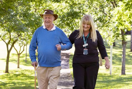 Whiddon community care worker walkin with a client