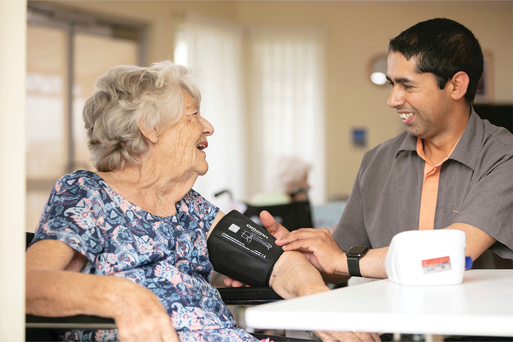 Whiddon nurse checking client's blood pressure