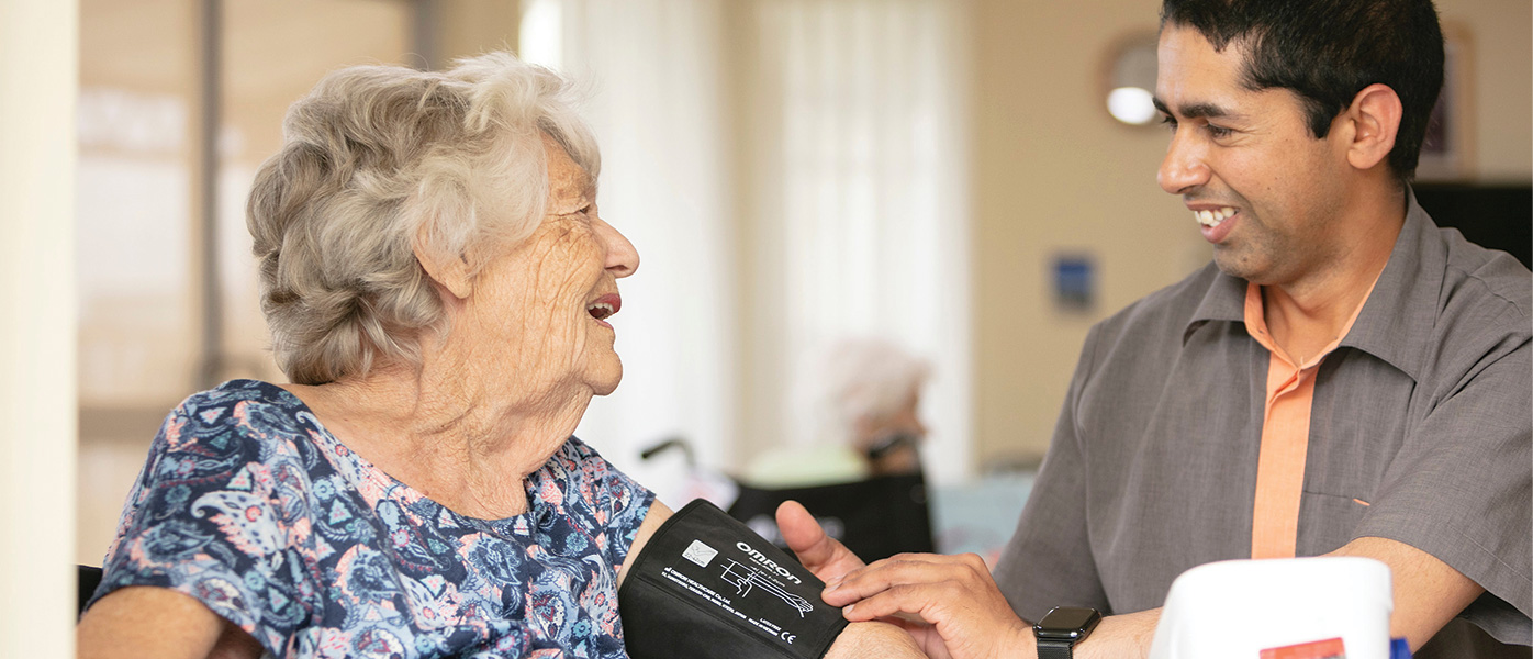 Whiddon nurse checking client's blood pressure