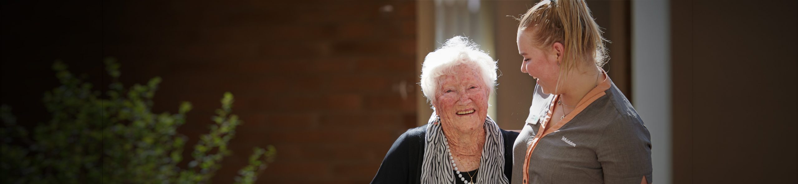 An Aged Care worker hugs a resident 