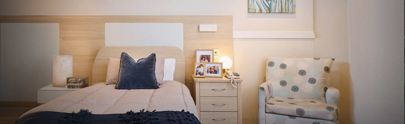 bedroom with beautiful bed set up and chair next to bed