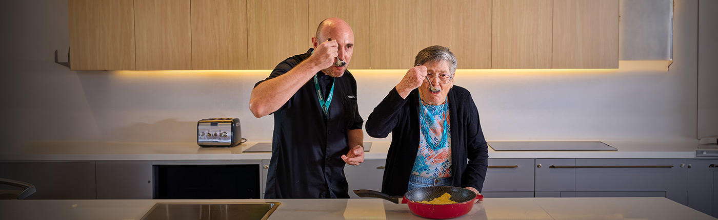 resident and chef enjoying some food together