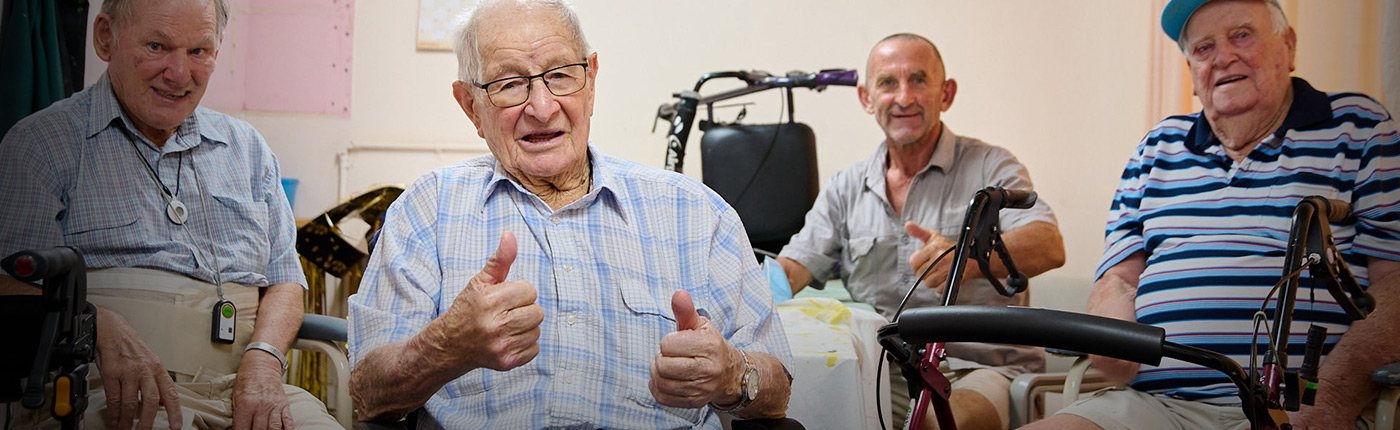 male residents sitting in a group together