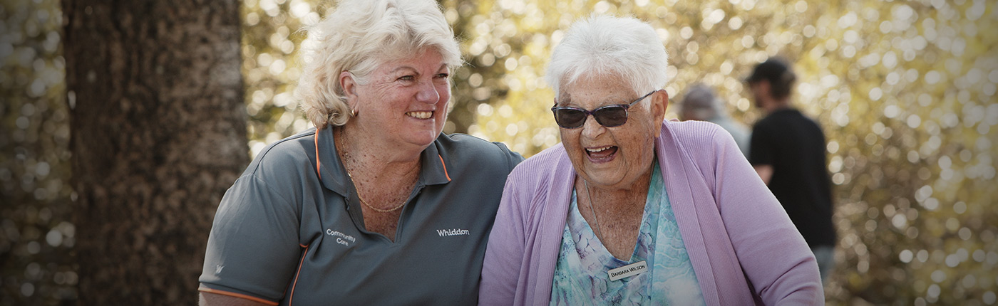 care worker having a laugh with a female resident