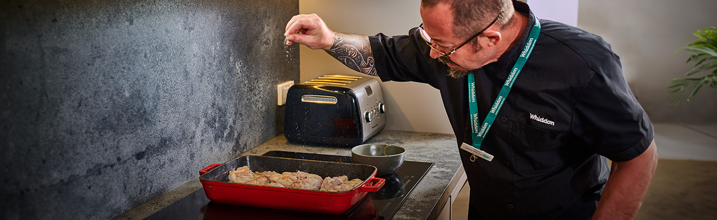Chef Jason sprinkling salt over some delicious home cooked food