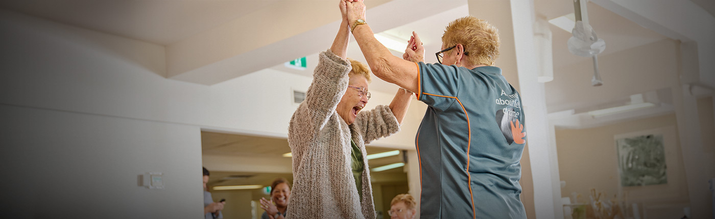 whiddon resident employee hands up together