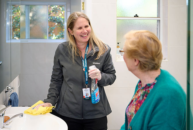 Home Care employee helps cleaning the bathroom for an elderly family