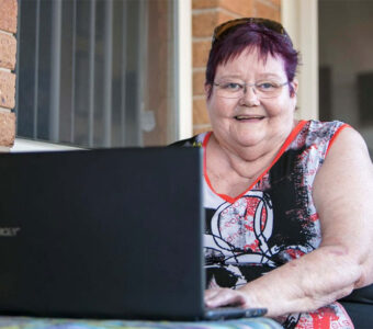 Chris, a Whiddon resident, happily enjoying some time using her laptop.