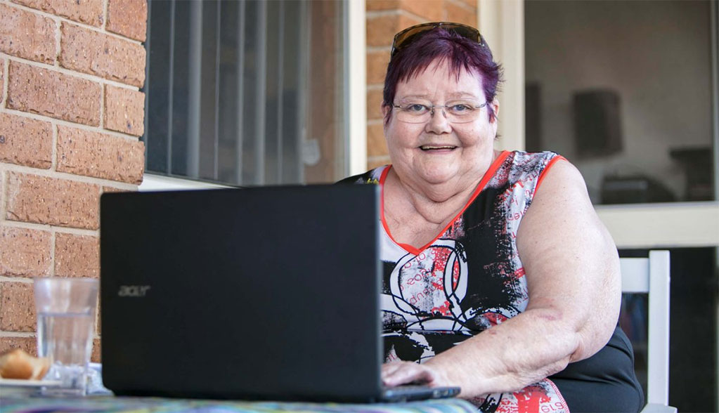 Chris, a Whiddon resident, happily enjoying some time using her laptop.