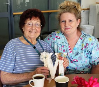 A resident and carer enjoying some coffee during Chat, Stories and Tea, Whiddon's cognitive therapy program.