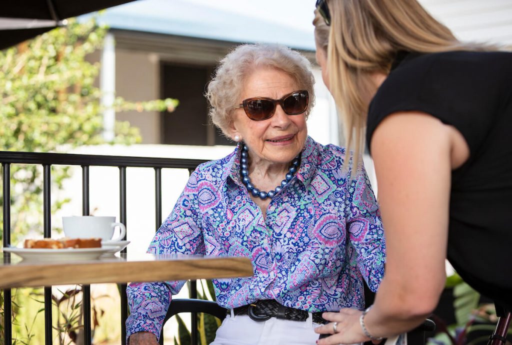 senior lady out at coffee shop with carer