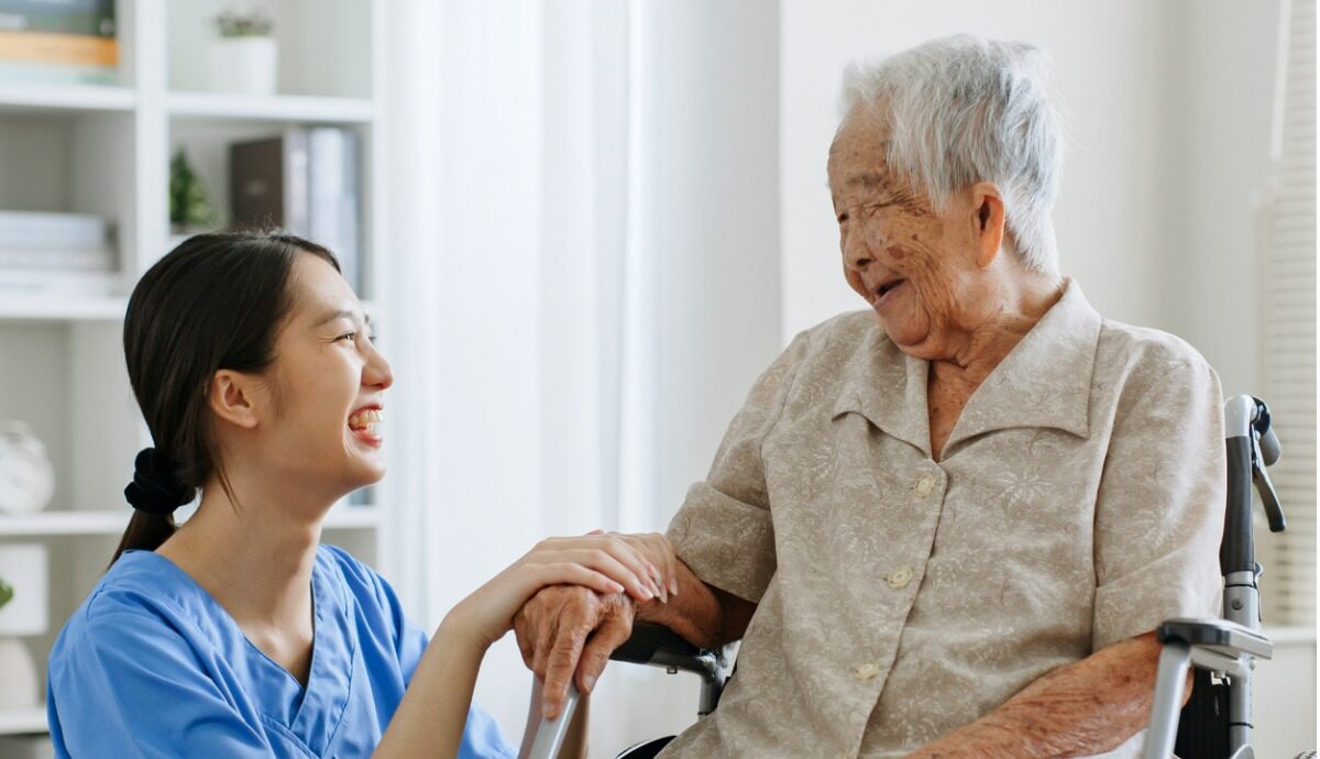 aged care worker smiling with client
