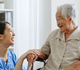 aged care worker smiling with client