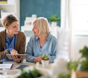 aged care caregiver discussing with older adult client.