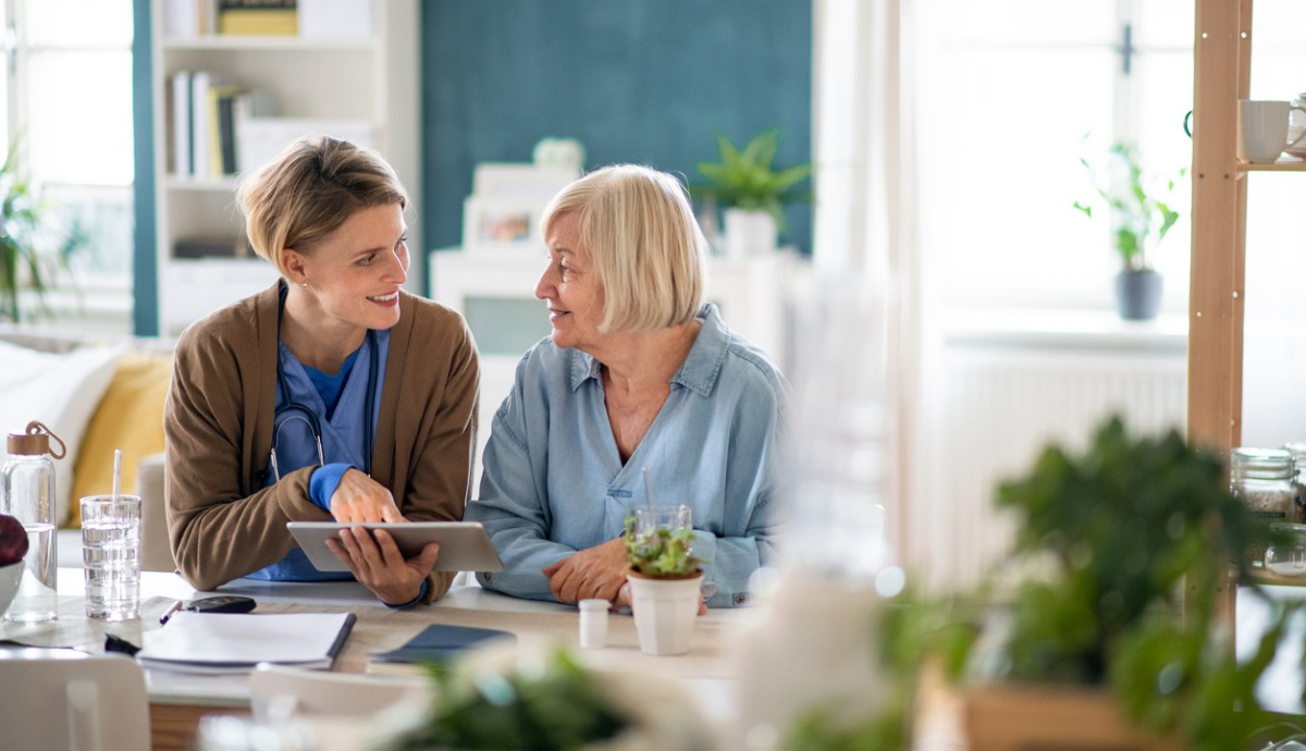 aged care caregiver discussing with older adult client.