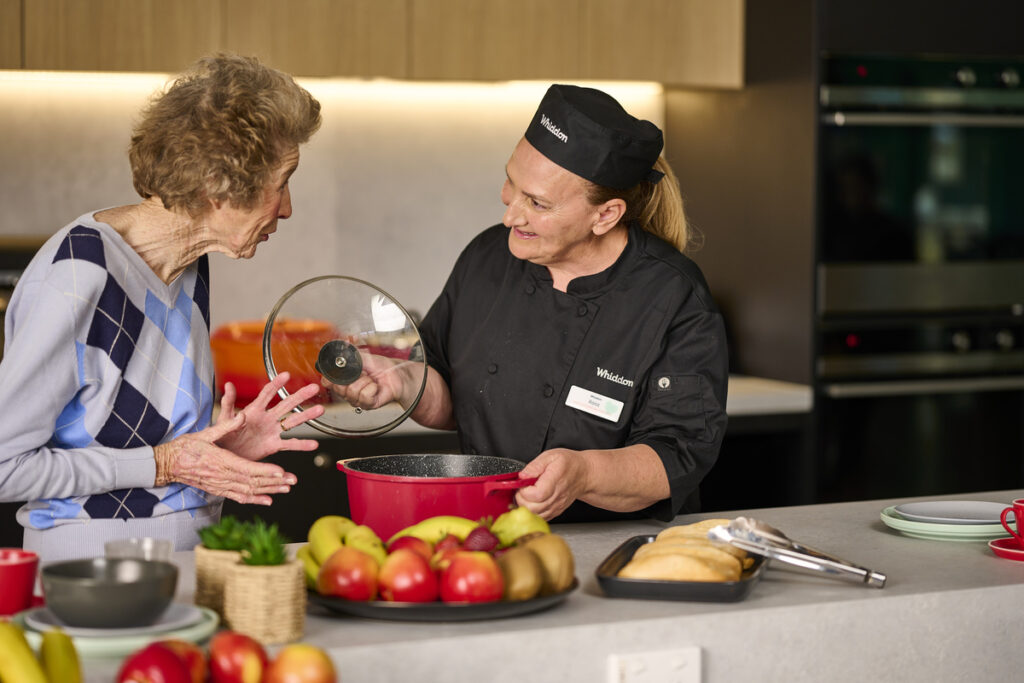 chef showing resident aged care meals
