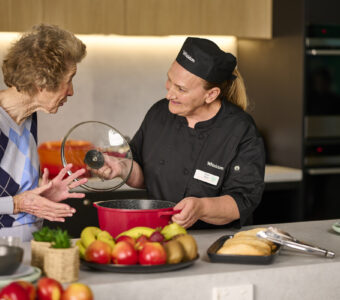 chef showing resident aged care meals