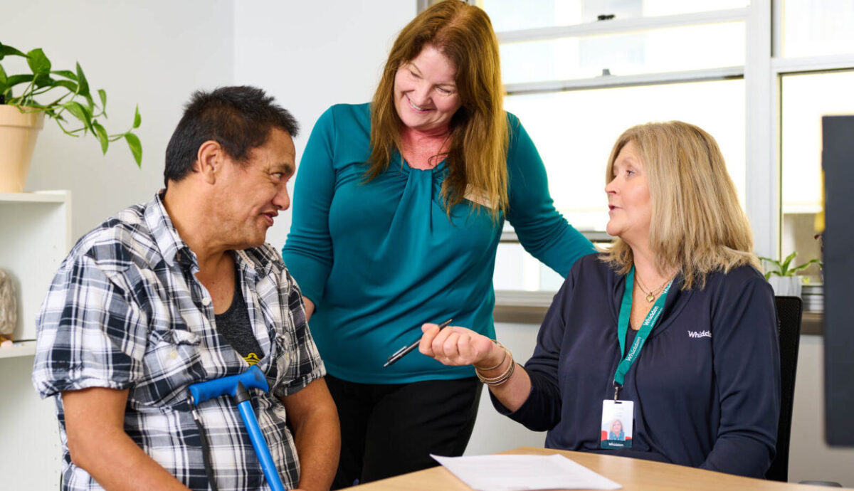 ndis particpant talking to two disability support workers