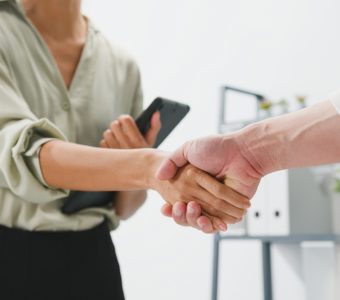 woman shaking the hand of another person