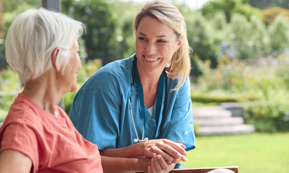 nurse sitting with an older woman