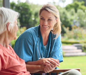 nurse sitting with an older woman