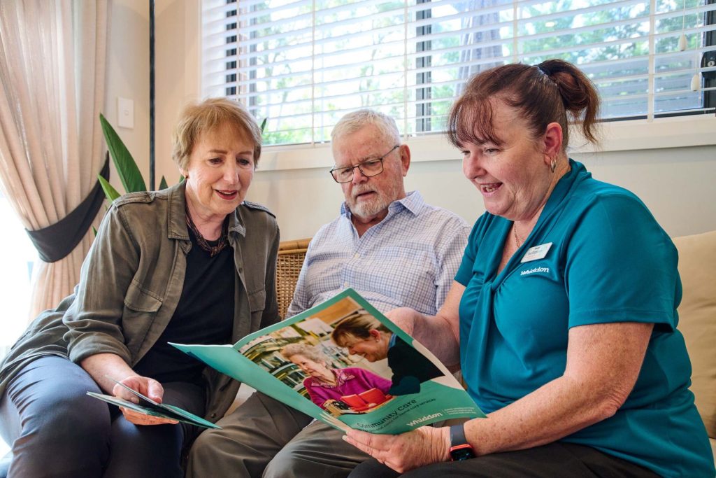 home care worker talking with an older male and female client