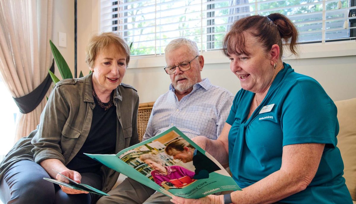 home care worker talking with an older male and female client