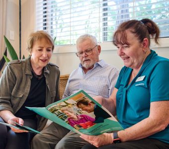 home care worker talking with an older male and female client