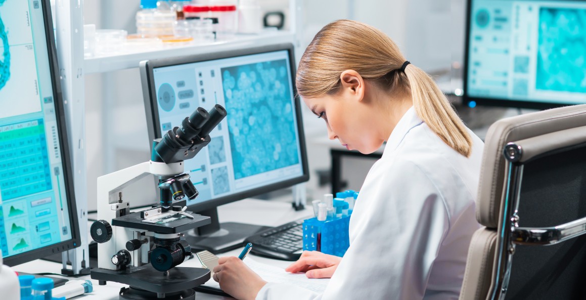 female scientist in lab writing notes