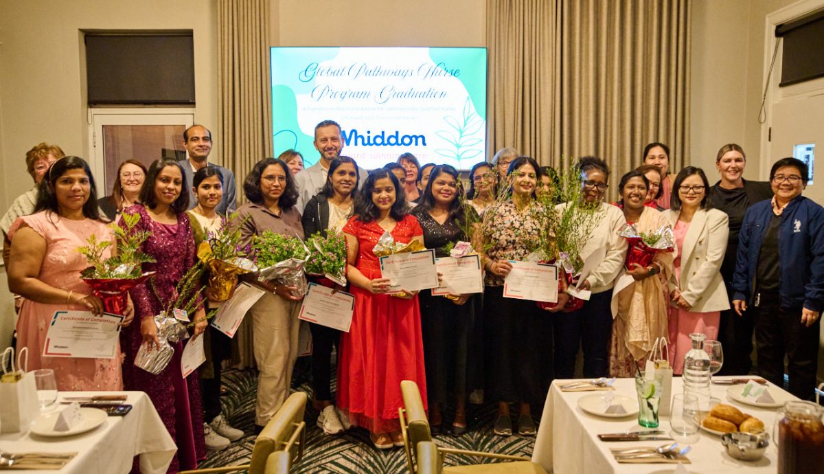 group of aged care nurse graduates standing with awards with Whiddon CEO Chris Mamarelis